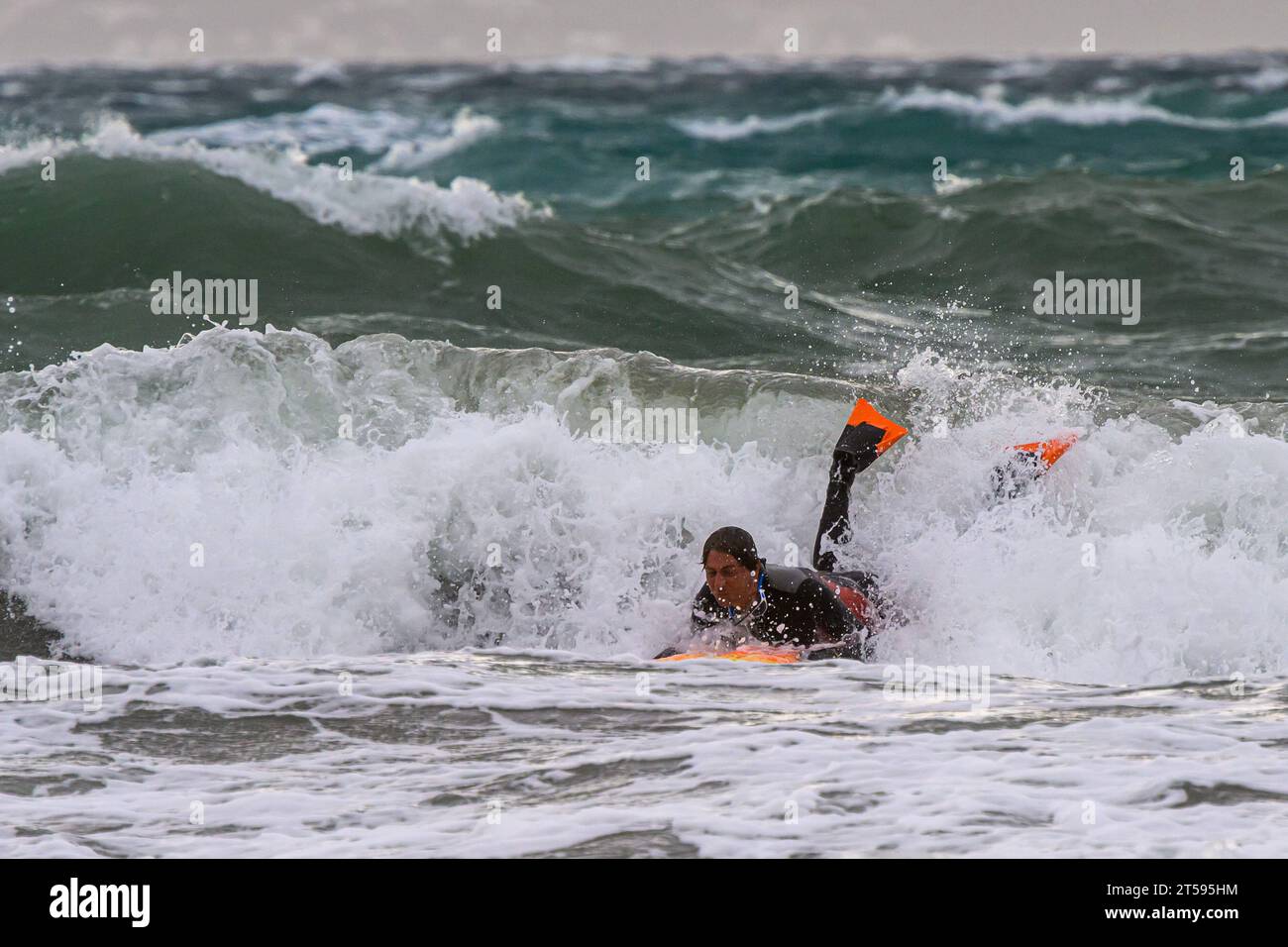 Croatia, Split, 031123. The stormy south changed to a southwesterly wind and created large waves that cause problems in maritime traffic and floods due to rising sea levels. In the photo: a brave surfer tries to overcome big waves along the coast of Bacvica. Photo: Tom Dubravec/CROPIX Split CROATIA Copyright: xxTomxDubravecx jugo lebicada bacvice20-031123 Credit: Imago/Alamy Live News Stock Photo