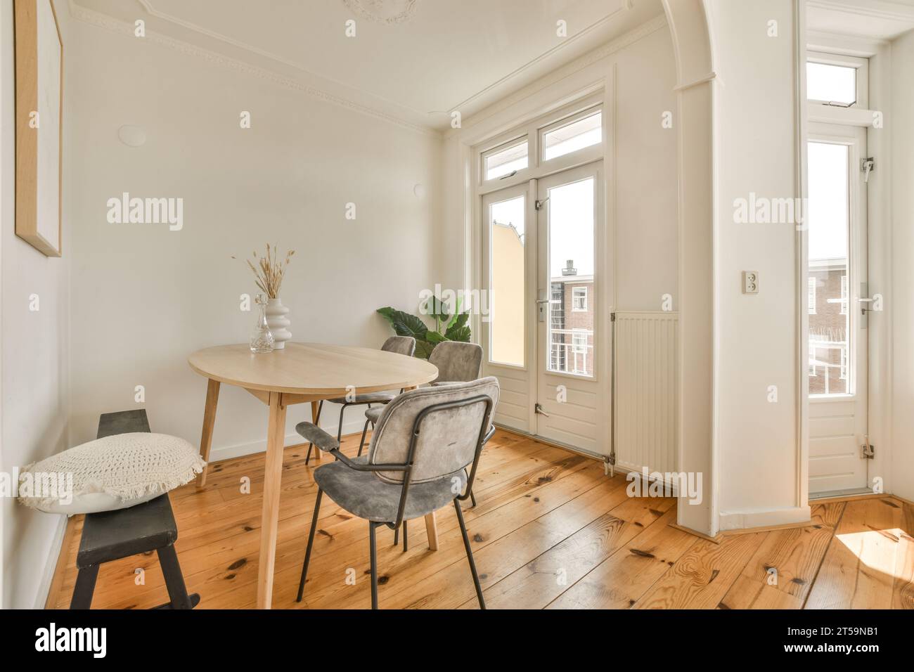 a dining table and chairs in a room with white walls, hardwood flooring ...