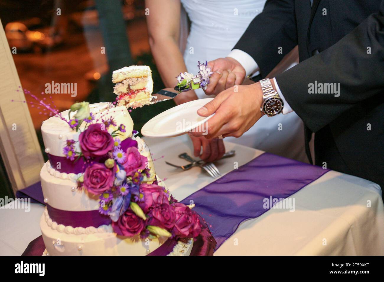 Newly Weds Cake Cutting the first slice Stock Photo
