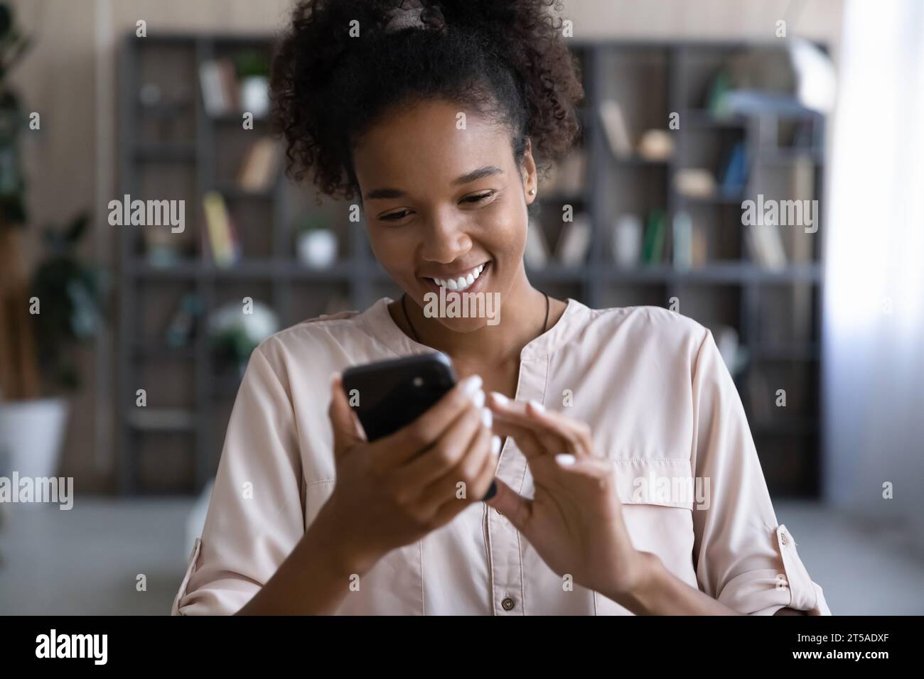 Happy Black millennial gen Z girl flirting on dating website Stock Photo
