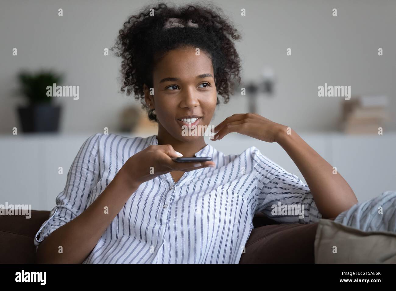 Pretty beautiful African American teen girl with Afro hairstyle looking at  camera, posing for shooting at home. Black teenage high school student,  teenage schoolgirl head shot portrait Stock Photo