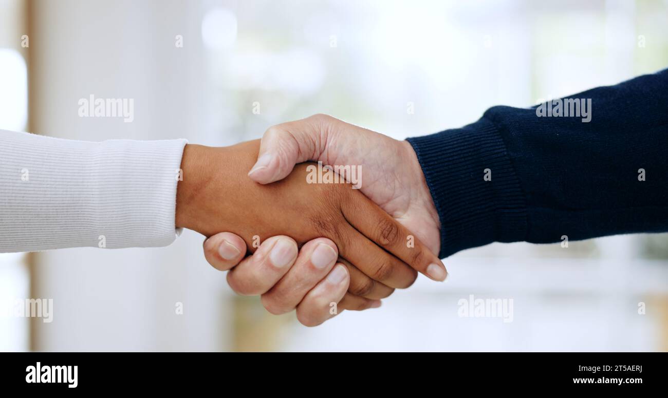 Handshake, agreement and closeup of business people in office for welcome to a new recruit or partnership. Zoom of professional female manager with Stock Photo