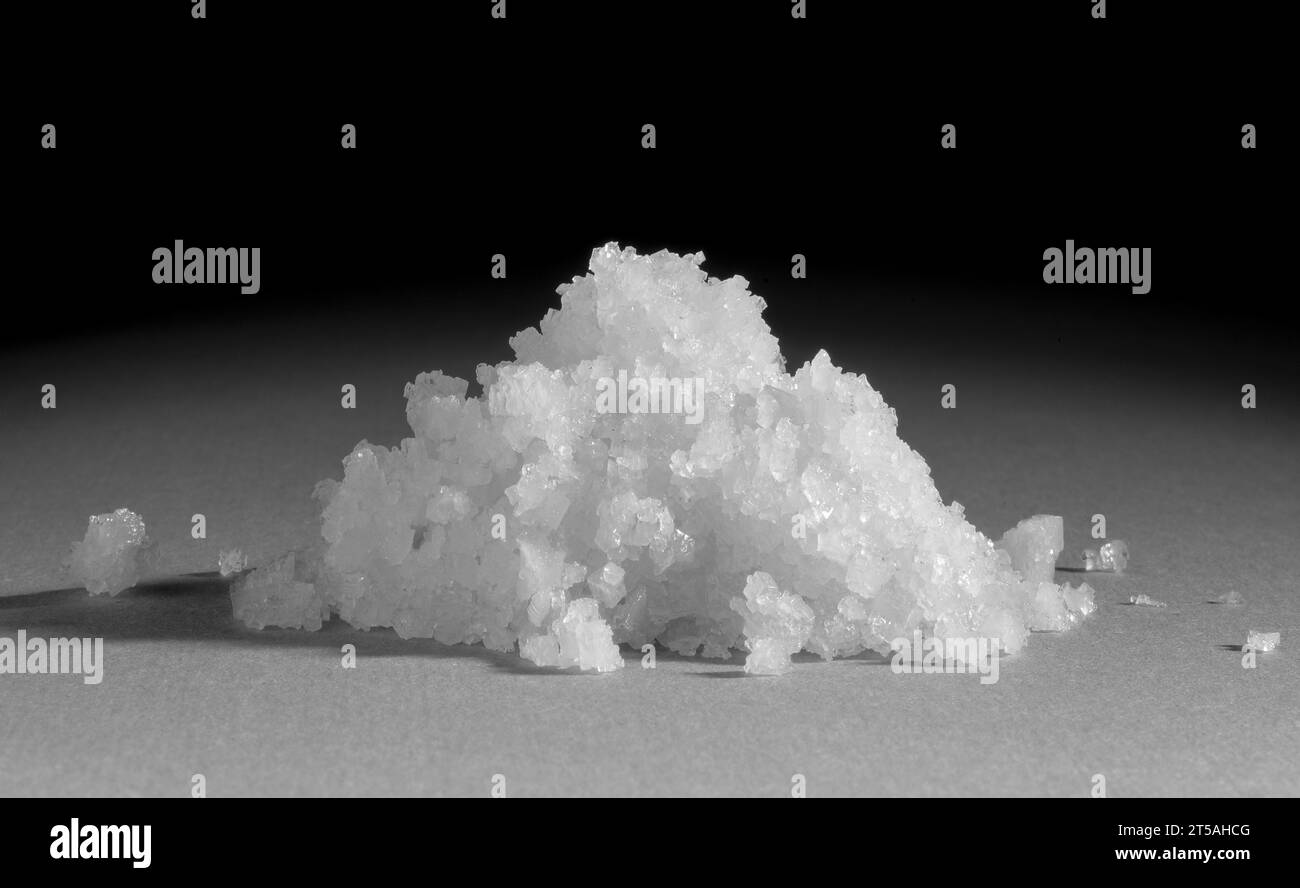 Sea salt flakes. Sea salt is produced by evaporating seawater Stock