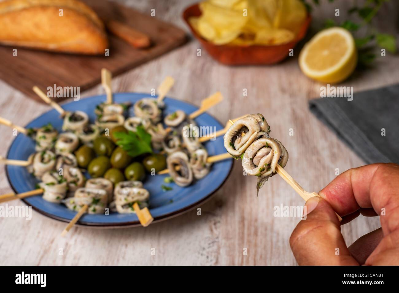 Skewer with anchovies in vinegar with garlic and parsley held in one