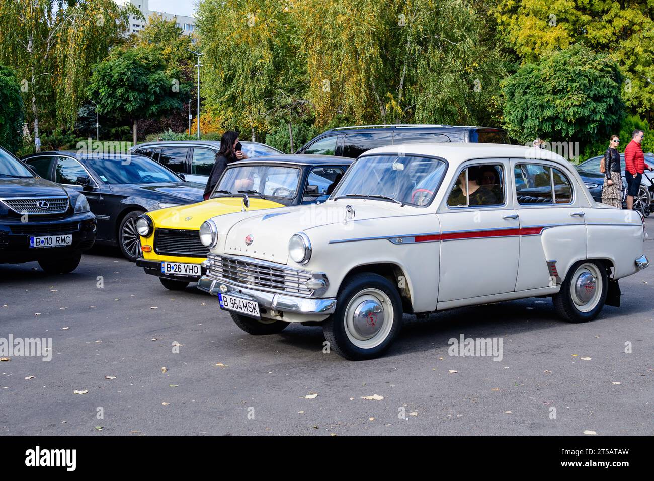 Bucharest, Romania, 24 October 2021: One vivid white Moskvitch 403 Russian vintage car in traffic in a street in the city center, in a sunny autumn da Stock Photo