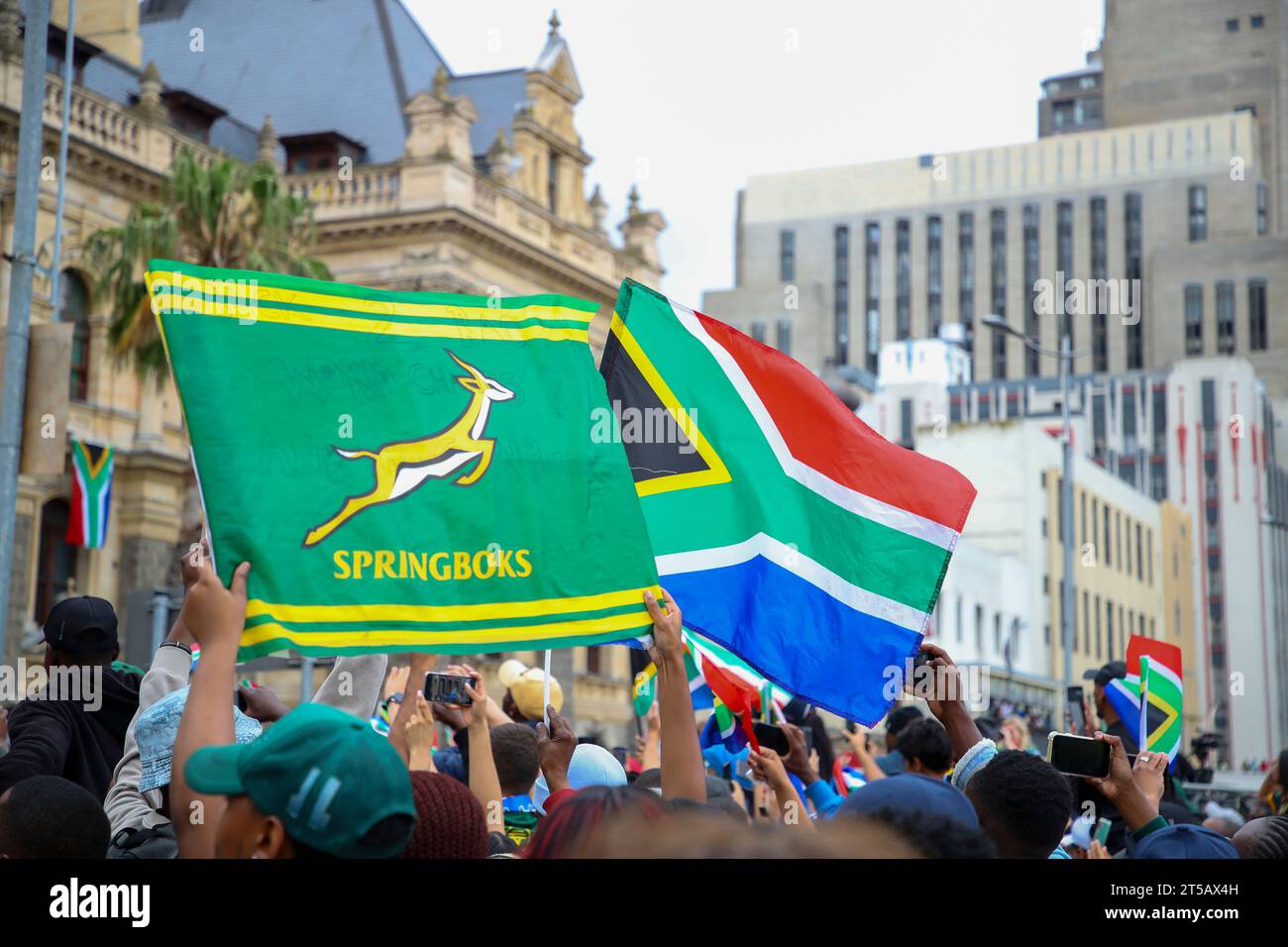CAPE TOWN, SOUTH AFRICA - NOVEMBER 03: fans wave a springbok flag and South African flag in front of the City Hall during the Springbok Trophy tour in Cape Town on November 03, 2023 in Cape Town, South Africa. The Springboks beat the New Zealand All Blacks 12-11 to win the Rugby World Cup in Paris, France on Saturday 28 October 2023. (Photo by Roger Sedres) Stock Photo