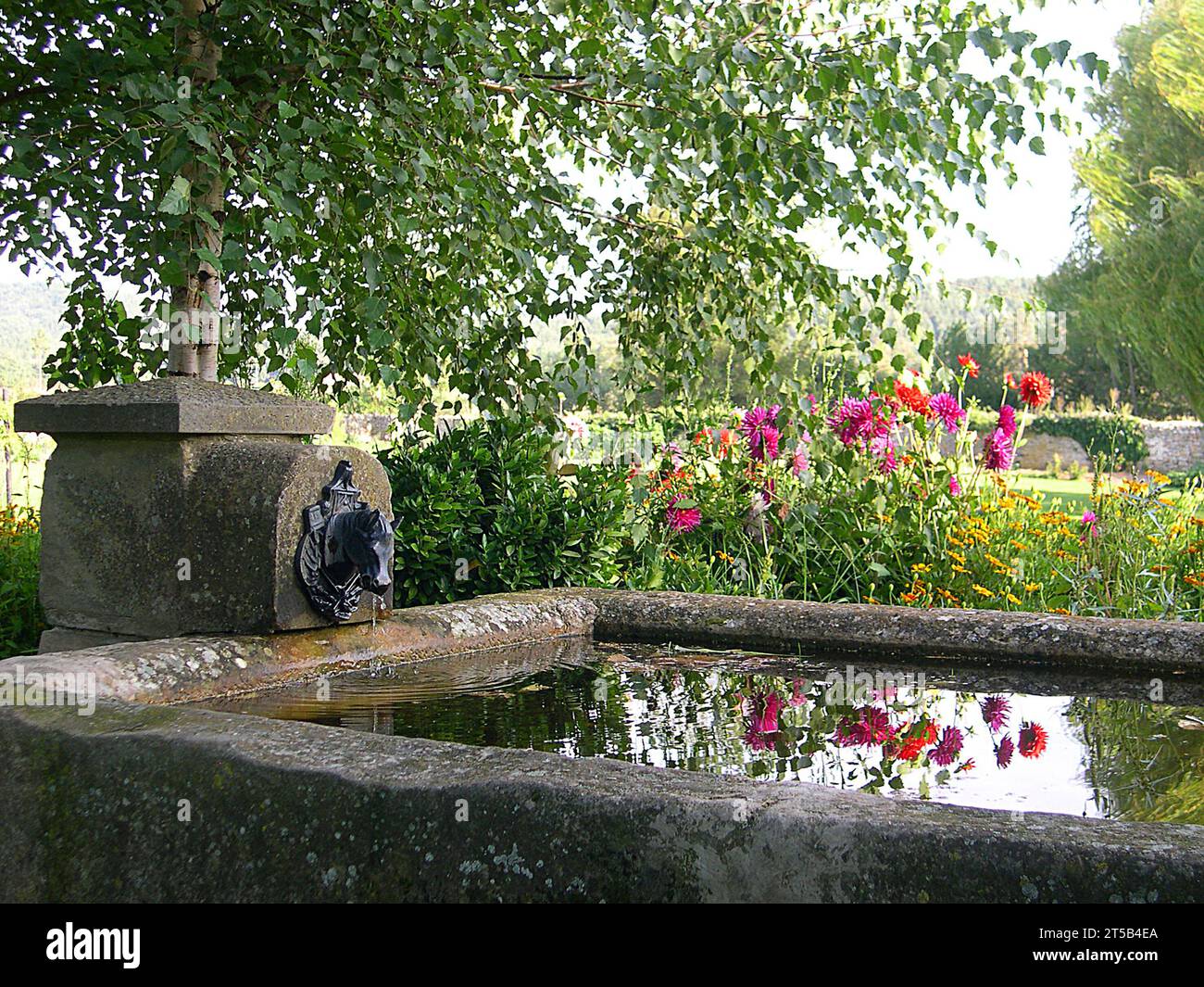 Fountain in a garden Stock Photo - Alamy