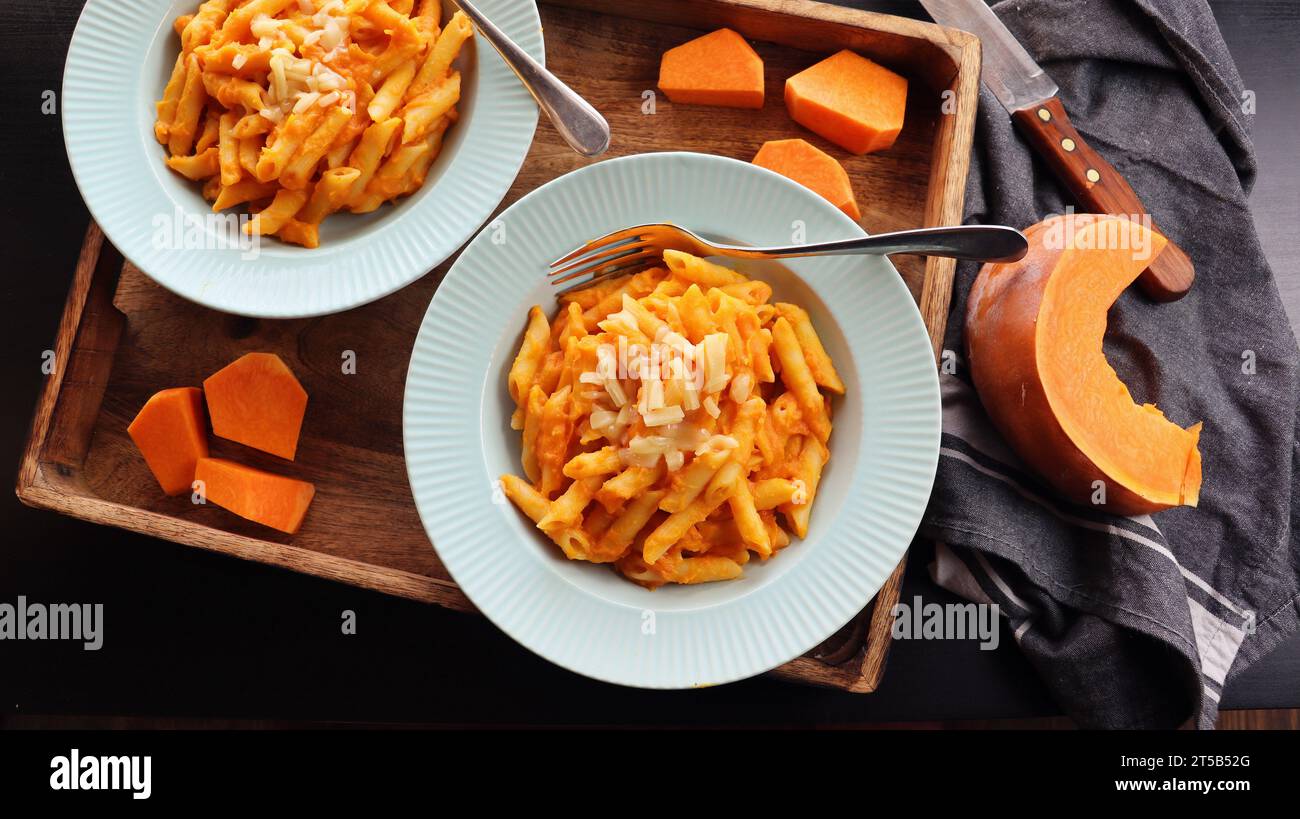 Healthy whole grain Penne, tube shaped pasta with pumpkin, goat cheese . Stock Photo