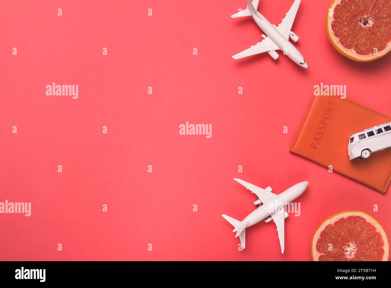 Composition toy airplanes bus passport grapefruit Stock Photo