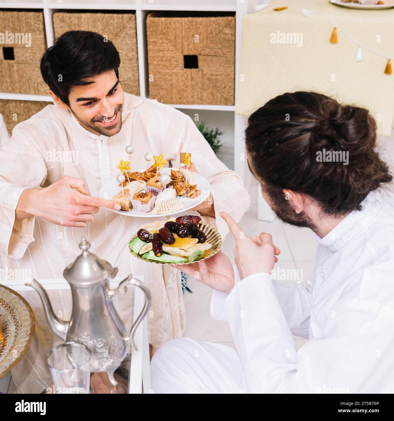 Eid al fitr concept with friends eating Stock Photo