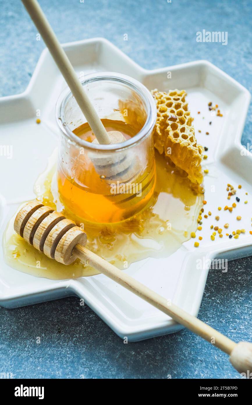 Honey pot with honey dipper honey comb floral tray Stock Photo