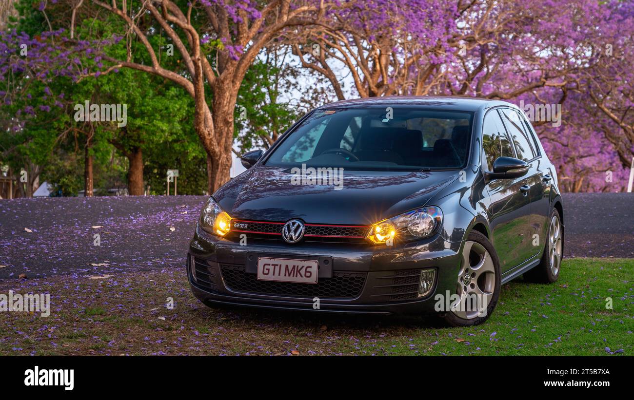 Grafton, NSW, Australia - Volkswagen Golf GTI MKVI parked among the jacaranda trees Stock Photo