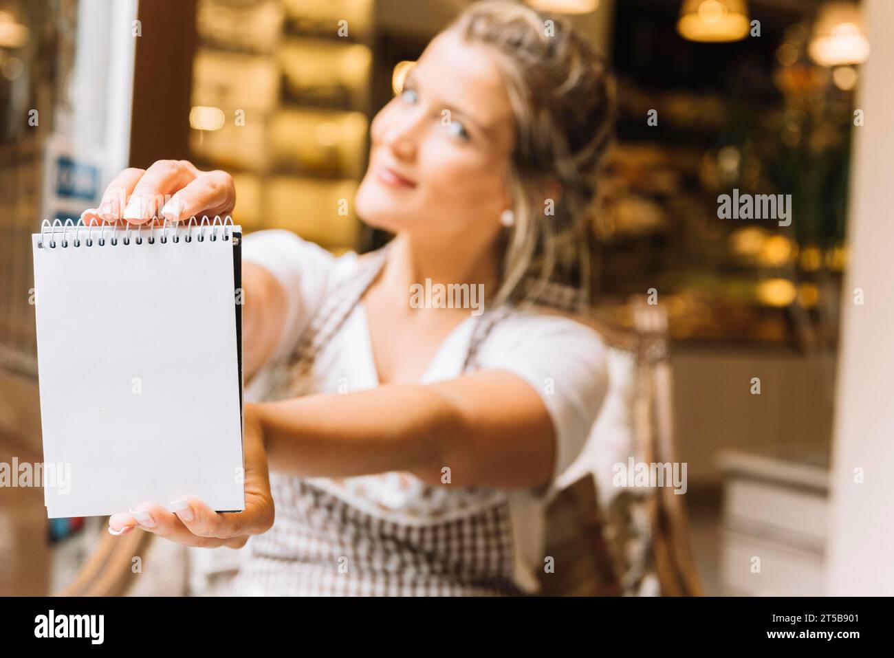 Waitress showing notebook Stock Photo