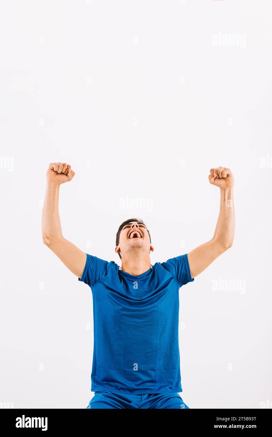 Young athlete looking up celebrating success Stock Photo