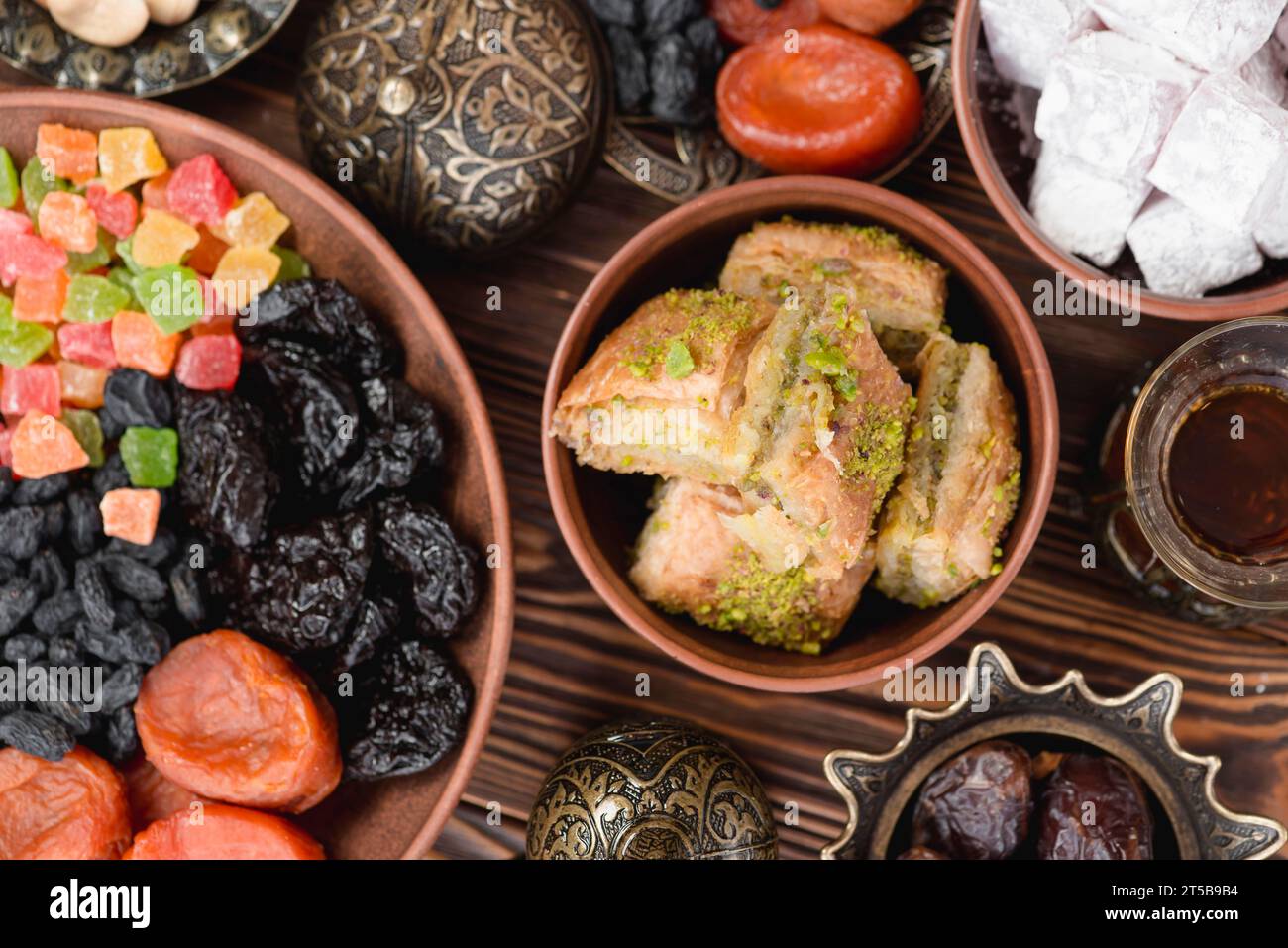 Arabian sweets ramadan baklava lukum dried fruits bowl desk Stock Photo