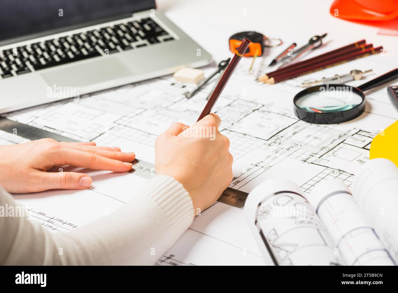 Architect drawing blueprint with pencil Stock Photo
