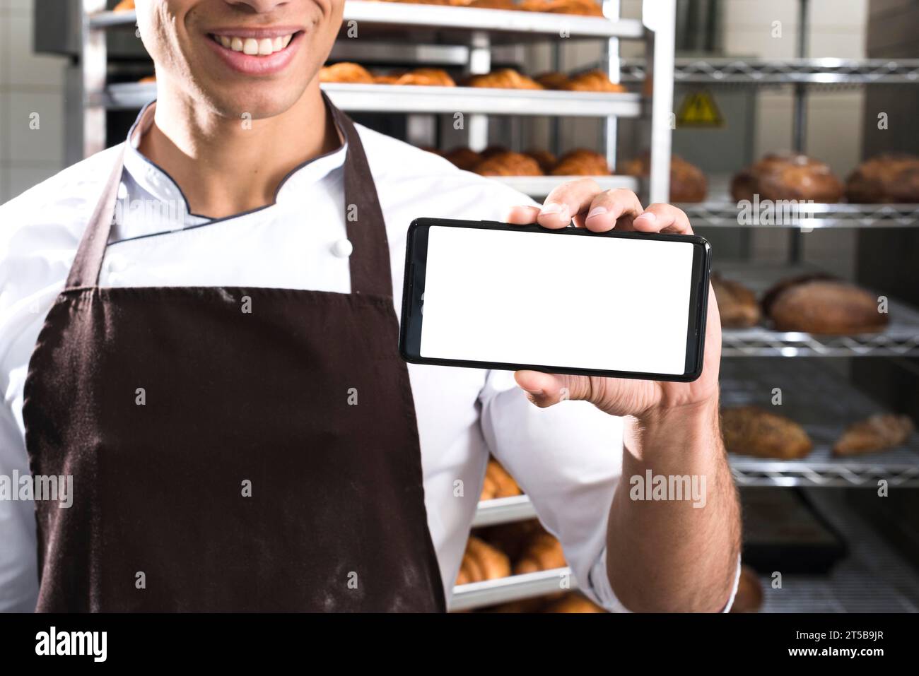 Chef showing screen phone Stock Photo