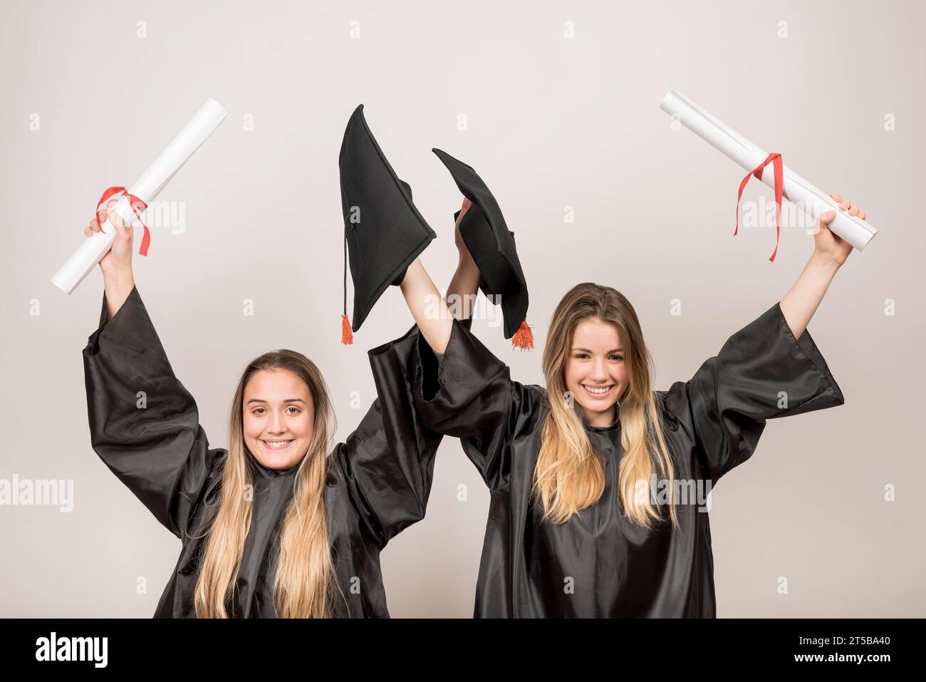 Enthusiastic graduates looking camera Stock Photo
