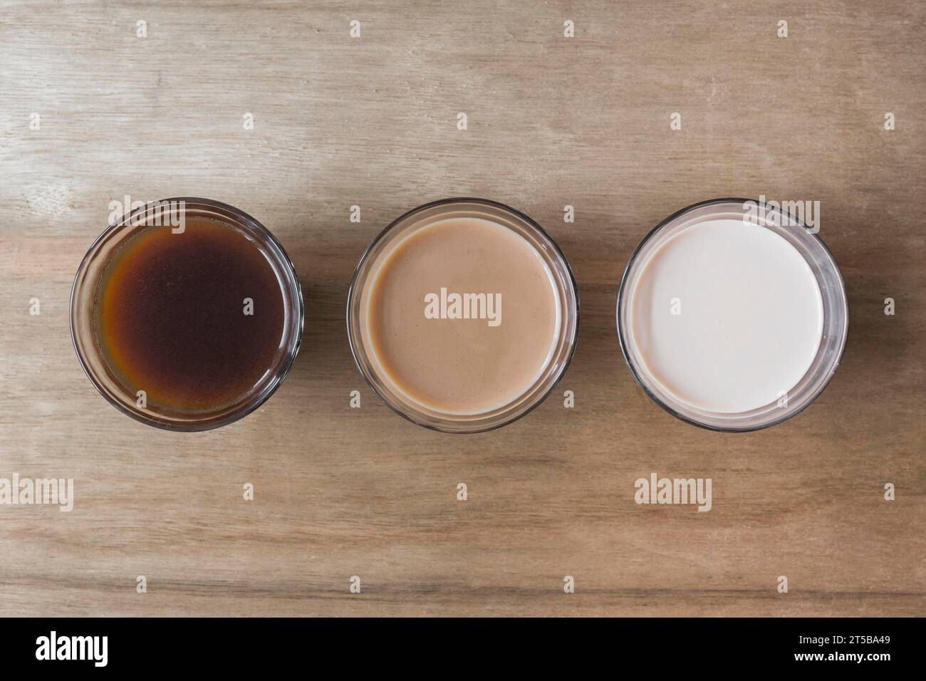 Different type beverage wooden texture backdrop Stock Photo - Alamy