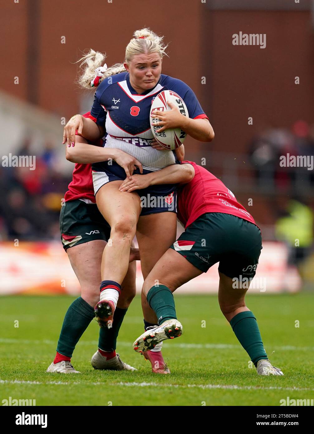 England's Zoe Hornby (centre) is tackled by Wales' Hannah Jones (left ...