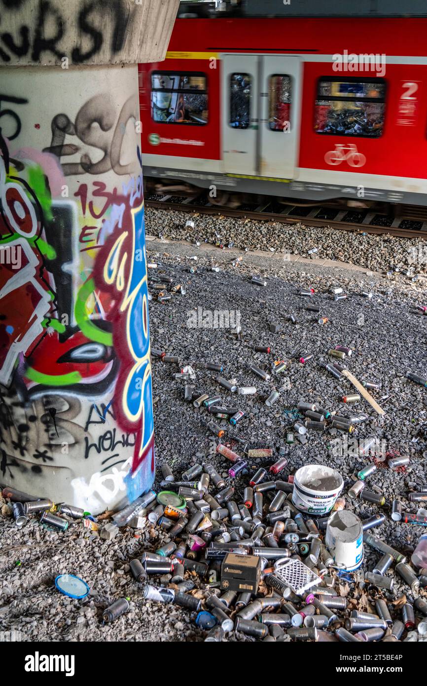 Empty spray paint cans, on a railway track below a road bridge, thrown away, disposed of by the sprayer, graffiti, rubbish heap, Essen, NRW, Germany, Stock Photo