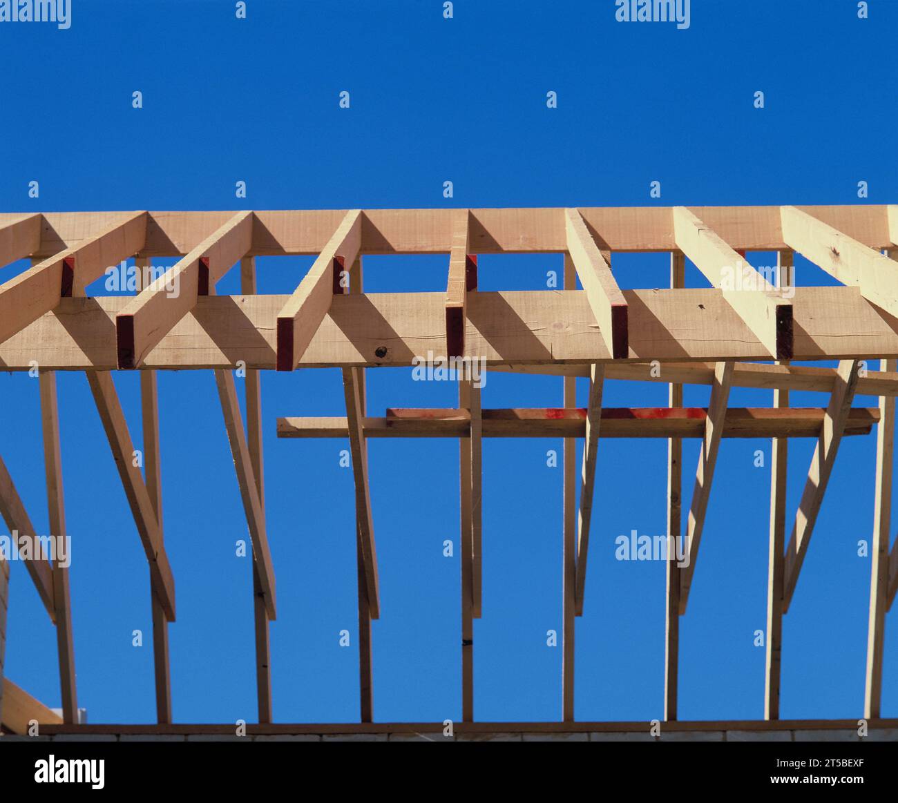 Architecture. Construction industry. New building wooden roof trusses. Stock Photo
