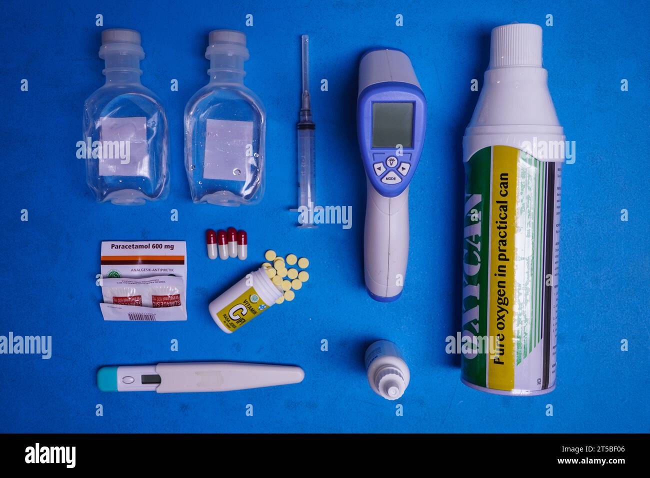 DENPASAR, 10 AUG 2021: some kinds of medicine things, there are pracetamol, pills, tablets, thermometer gun, thermometer, nose healer, oxygen, syringe Stock Photo