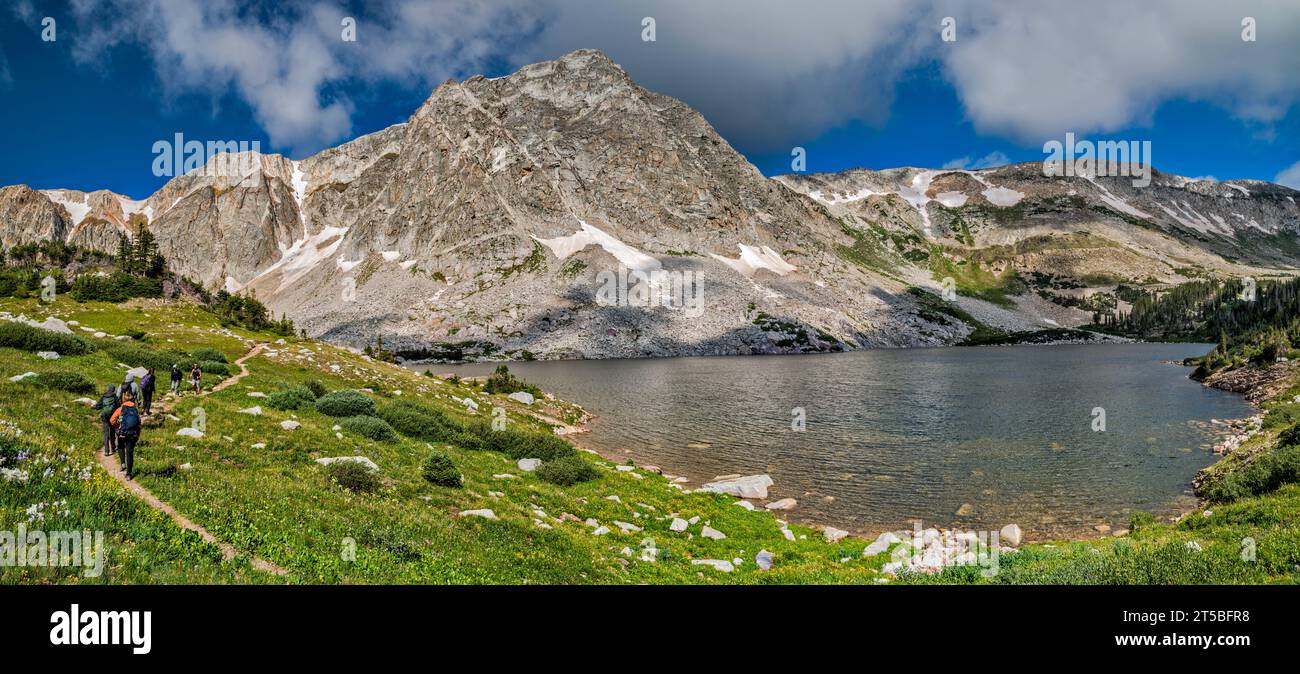 Snowy Range, Old Main Elevation in center, Medicine Bow Peak on right, Lookout Lake, hikers on Lakes Trail, mid-summer, Medicine Bow Mtns, Wyoming USA Stock Photo
