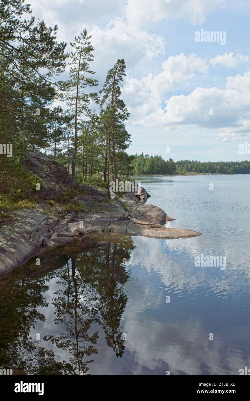 Landscape view of lake Meiko with shore forest reflecting on water surface, Meiko nature reserve, Kirkkonummi, Finland. Stock Photo
