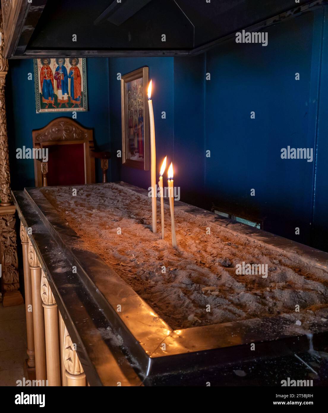 Burning candles inside a Greek monastery. Stock Photo