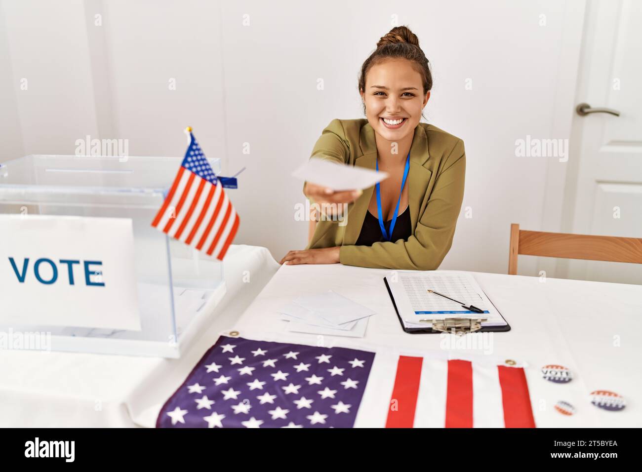 Young beautiful hispanic woman electoral table president holding vote at electoral college Stock Photo