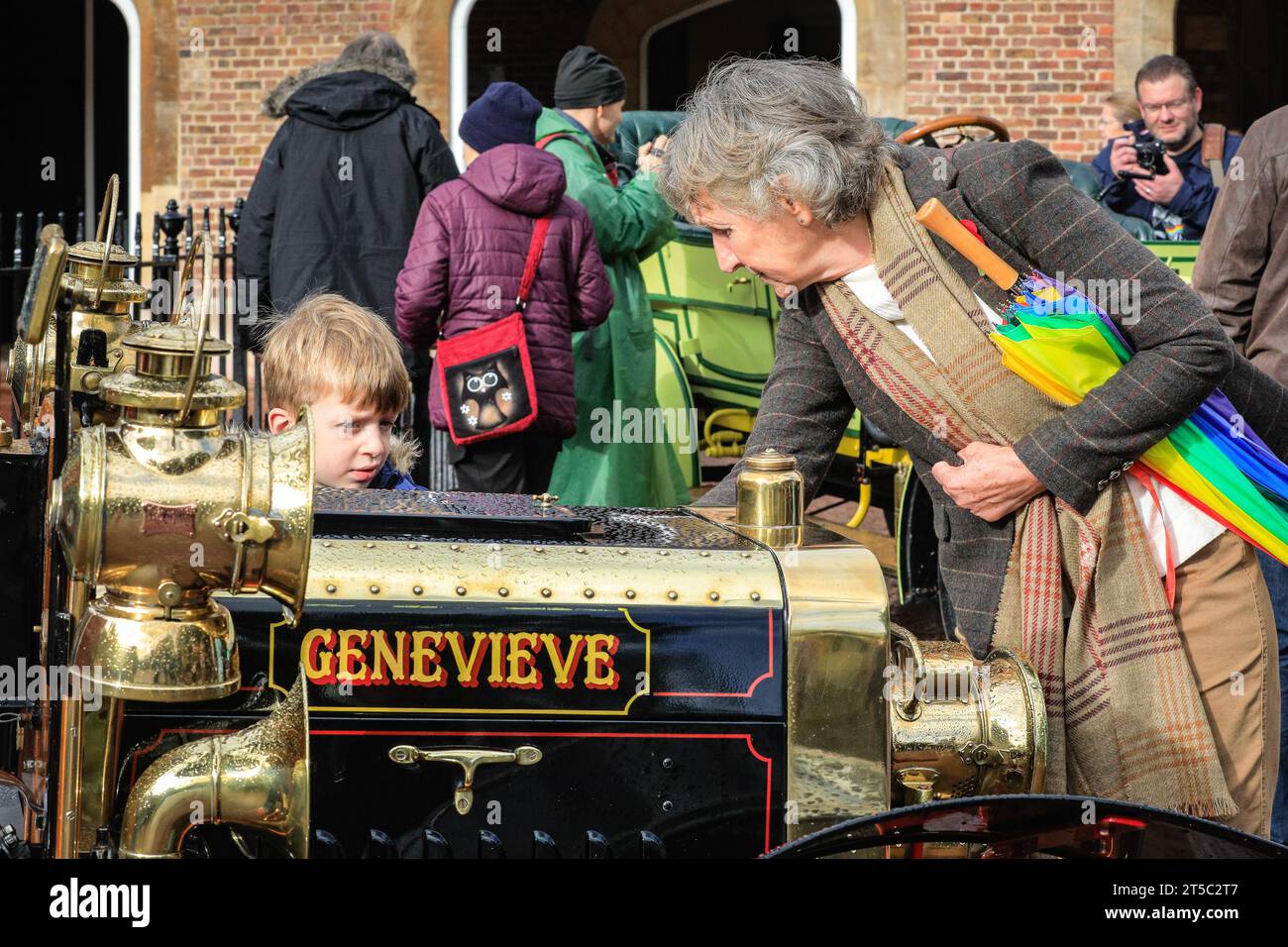 London, UK. 04th Nov, 2023. A woman and her grandson look at the 1904 Darracq called 'Genevieve', from the classic British film Genevieve. Over one hundred pre-1905 veteran cars are on display in the showcase event next to James's Palace, previewing the RM Sotheby's London to Brighton Run on Sunday. Credit: Imageplotter/Alamy Live News Stock Photo
