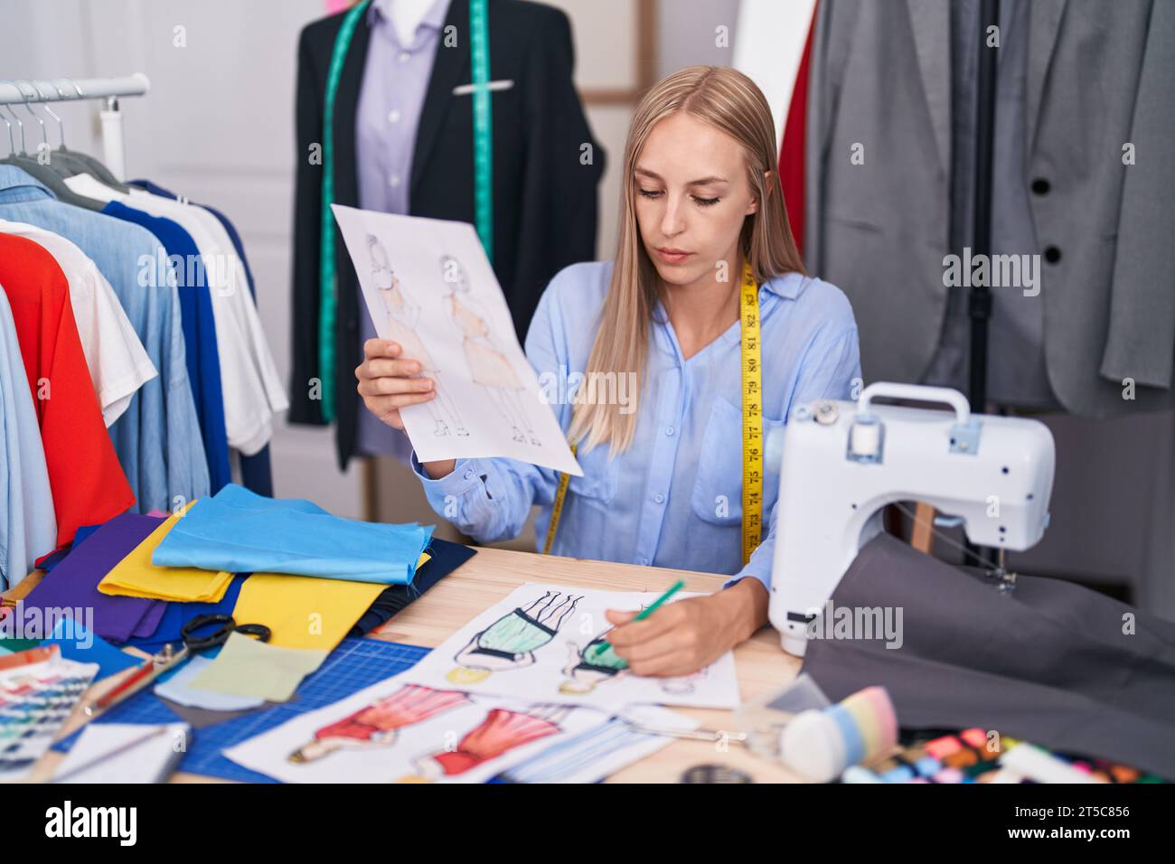 Blonde fashion designer drawing clothes hi-res stock photography and ...