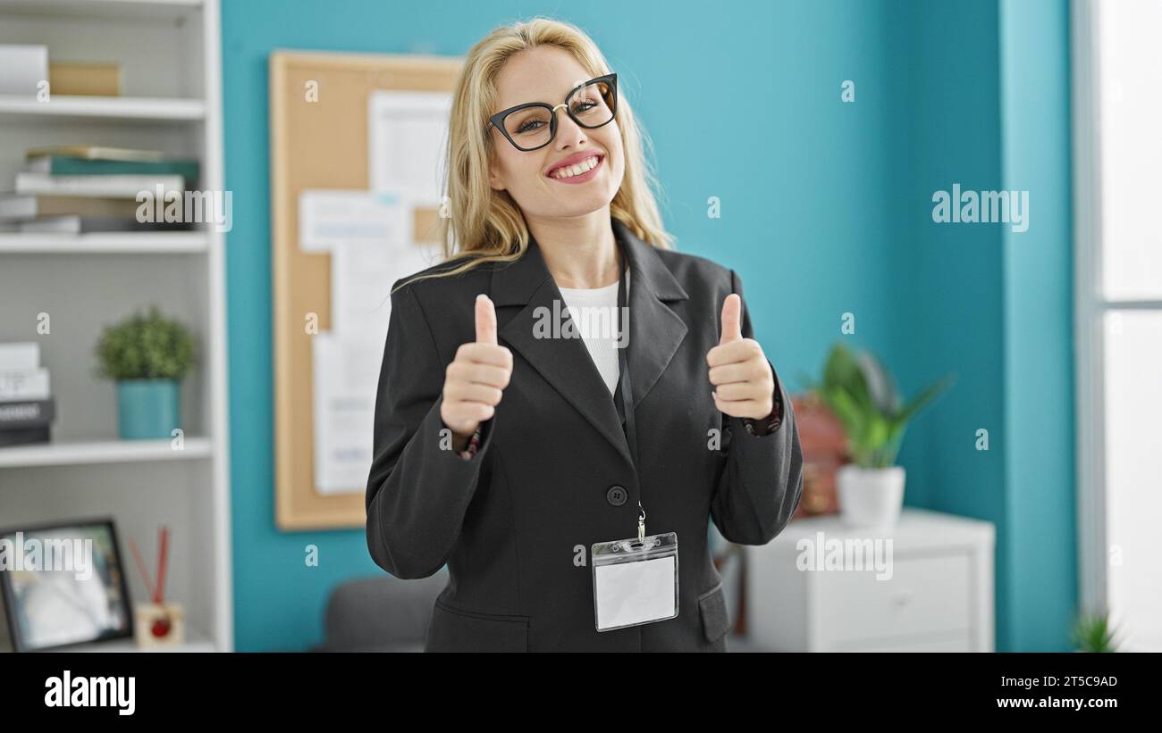 Young blonde woman business worker doing thumbs up gesture at the ...