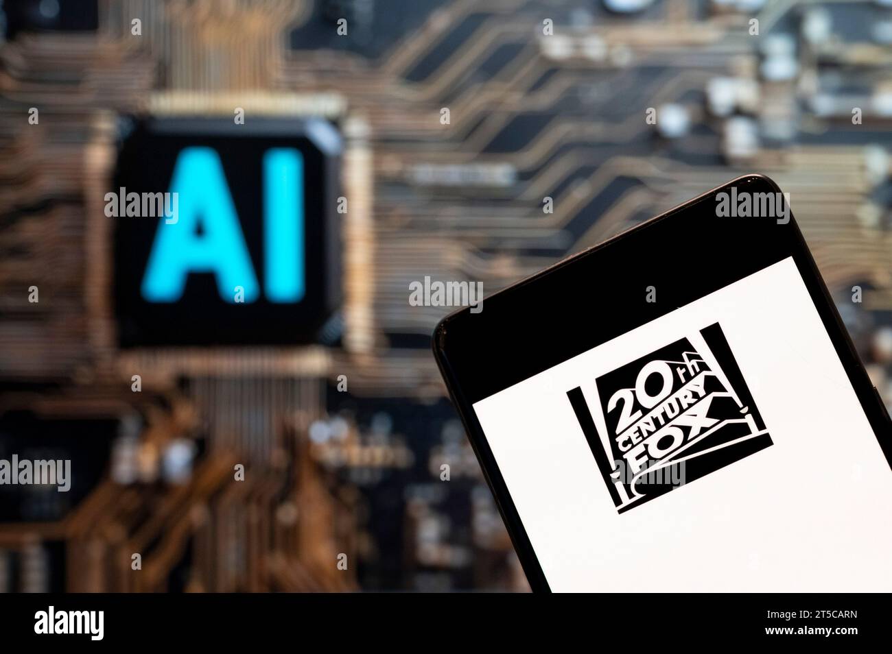 In this photo illustration, the American film studio Twentieth 20th Century Fox Film Corporation logo seen displayed on a smartphone with an Artificial intelligence (AI) chip and symbol in the background. Stock Photo