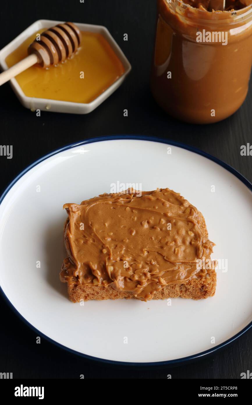 Peanut butter sandwich and honey Stock Photo Alamy