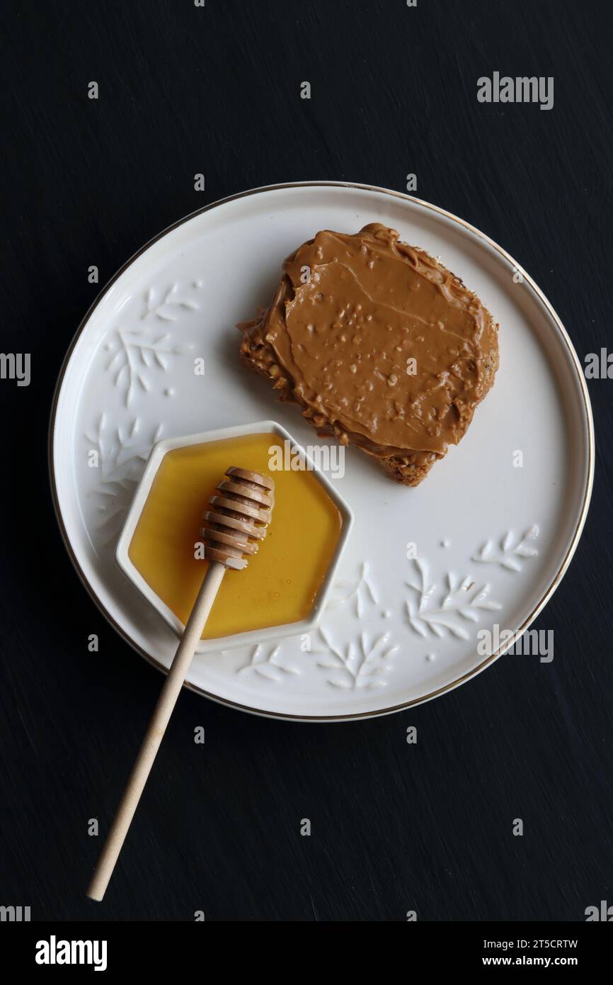Peanut butter sandwich and honey Stock Photo Alamy