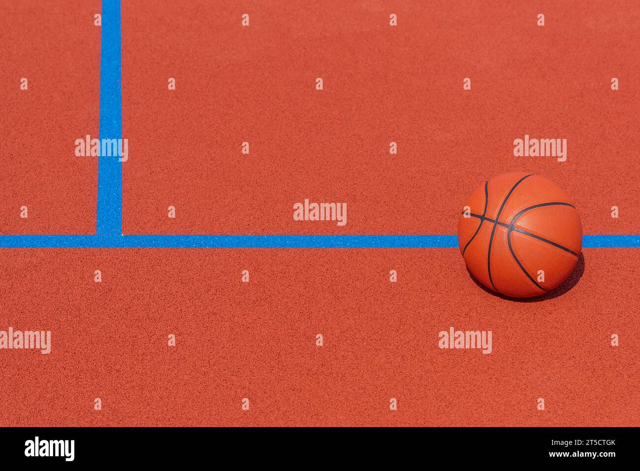 New orange basketball with blue line on orange court of gymnasium sport floor. Horizontal sport theme poster, greeting cards, headers, website and app Stock Photo