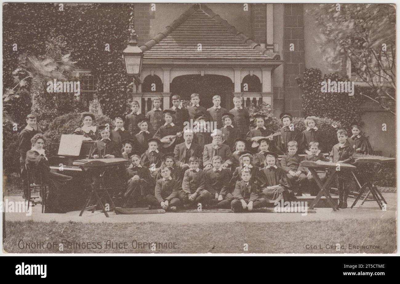 The choir of the Princess Alice Orphanage, Erdington, Birmingham, in the early 20th century. The children and teachers are grouped outside the house with a selection of musical instruments Stock Photo