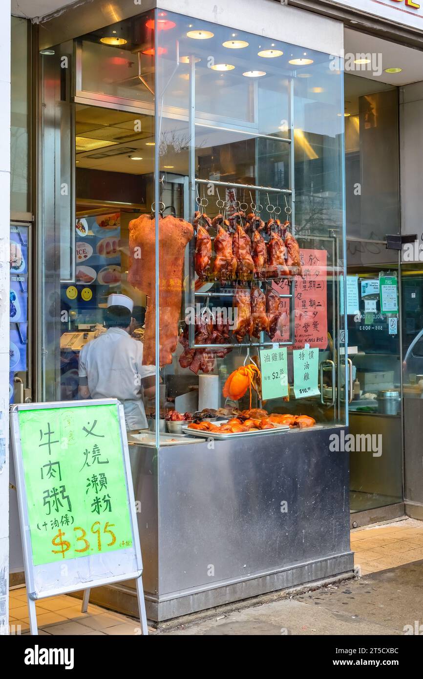 Toronto, Canada, 2013, Restaurant window displaying cooked birds in Chinatown. The business is named Gold Stone Noodl Restaurant. Scene with no people Stock Photo