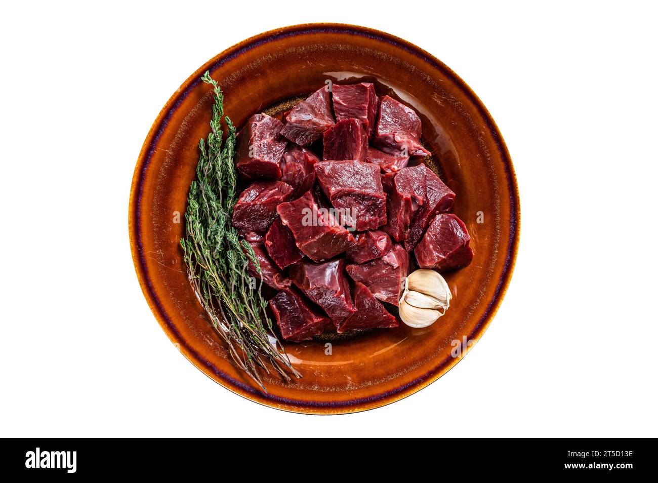 Cut Beef or veal raw heart in a rustic plate with herbs.Isolated on