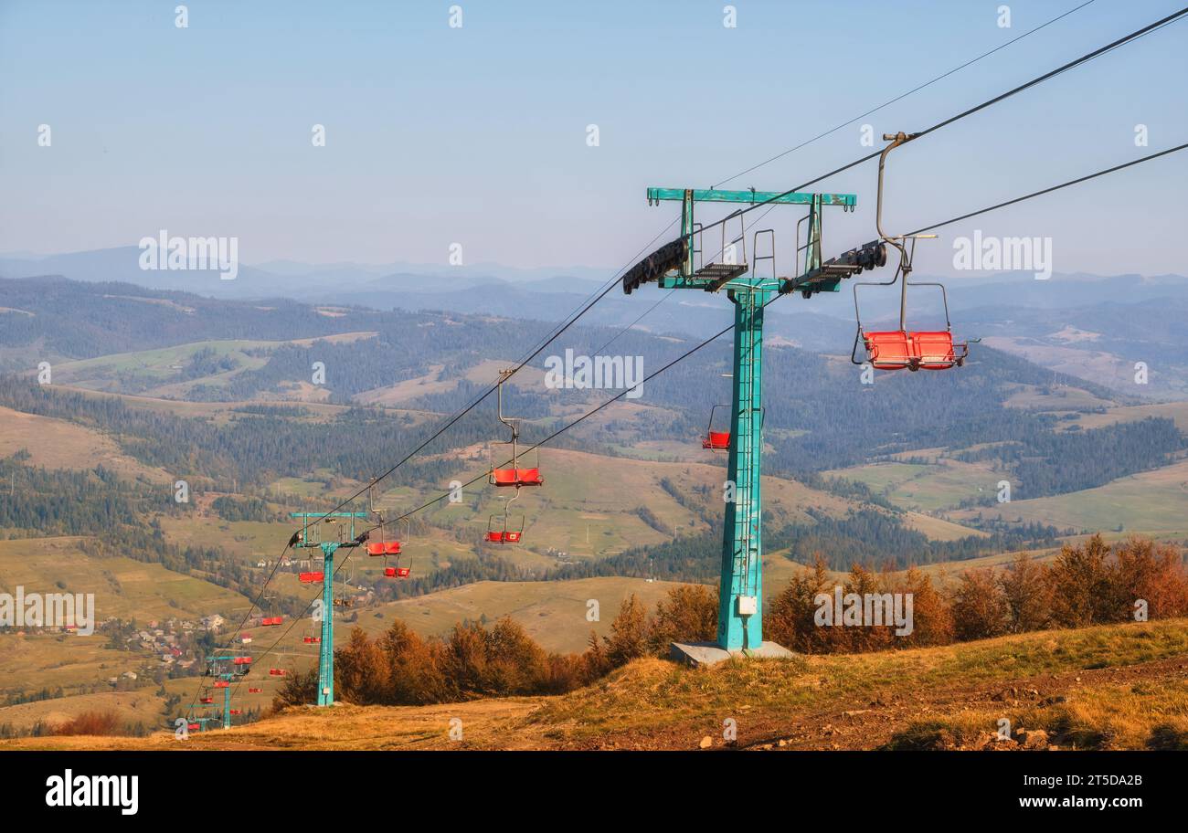 This captivating photo features an old cable car nestled in the backdrop of picturesque autumn mountains, basking in the warm glow of a sunny day. It Stock Photo