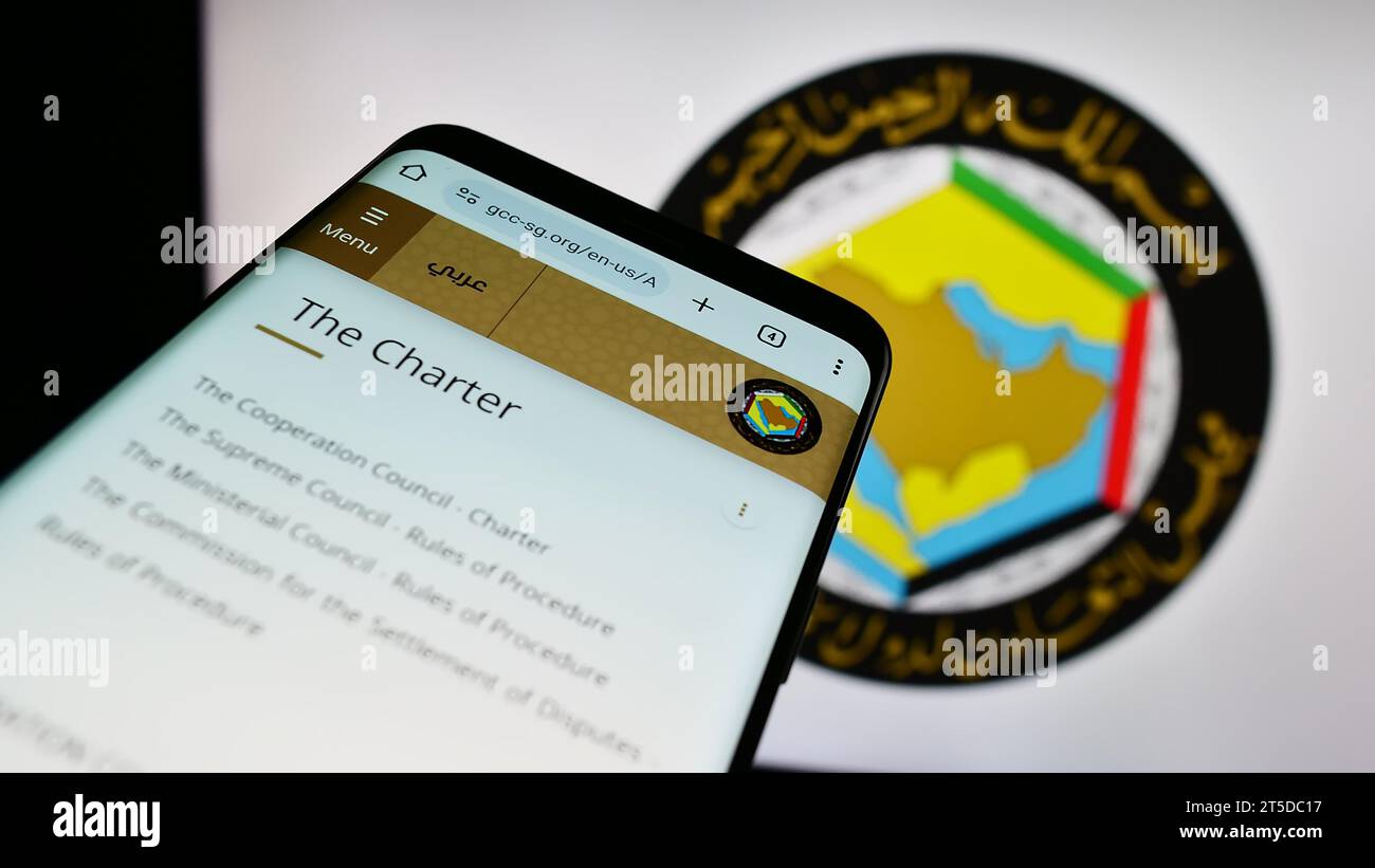 Mobile phone with website of Arab union Gulf Cooperation Council (GCC) in front of logo. Focus on top-left of phone display. Stock Photo