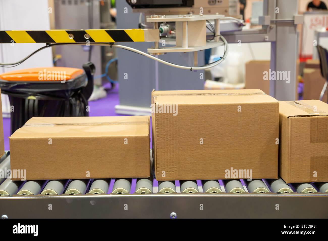 Cardboard boxes on industrial packaging tape Stock Photo - Alamy