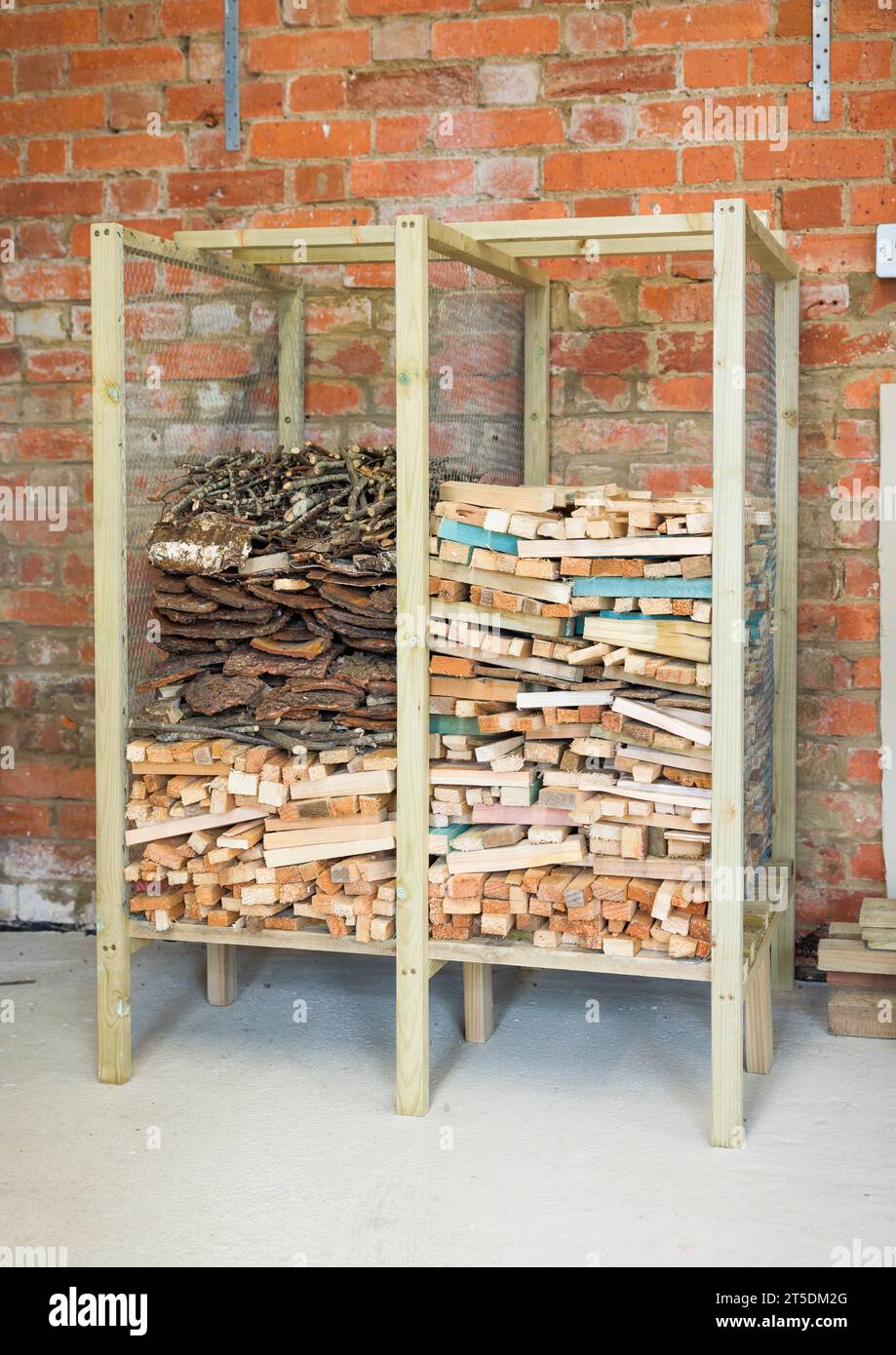 Wooden rack for storing kindling, kindling storage inside a garage, UK Stock Photo
