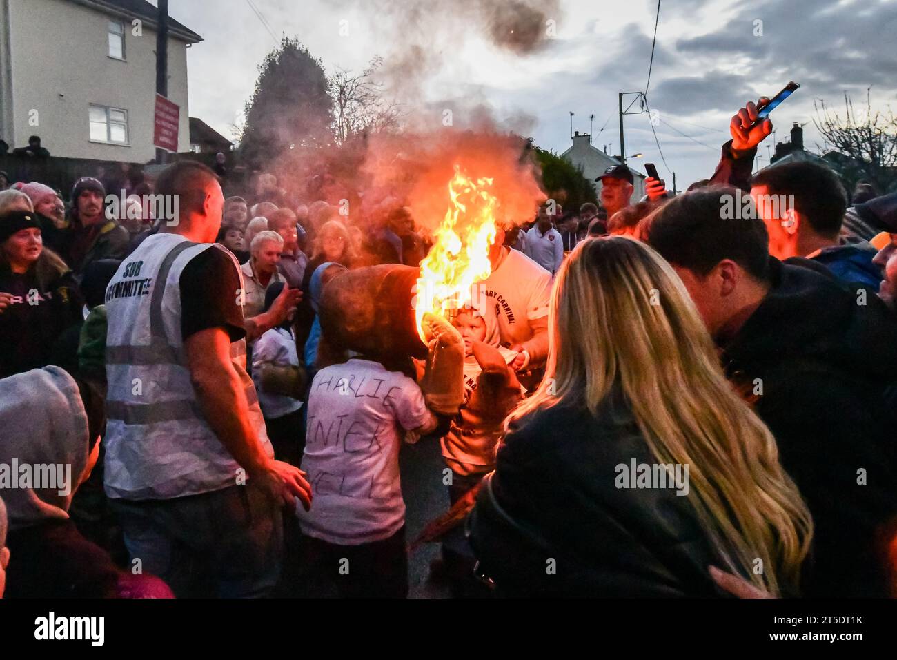 Ottery St Mary, UK. Saturday 4 November 2023. Brave children, as young as 7, take part in the Ottery St Mary Burning Tar Barrels. Running with burning barrels through the streets of Ottery St Mary, Devon in a traditional event stretching back hundreds of years. Credit: Thomas Faull/Alamy Live News Stock Photo