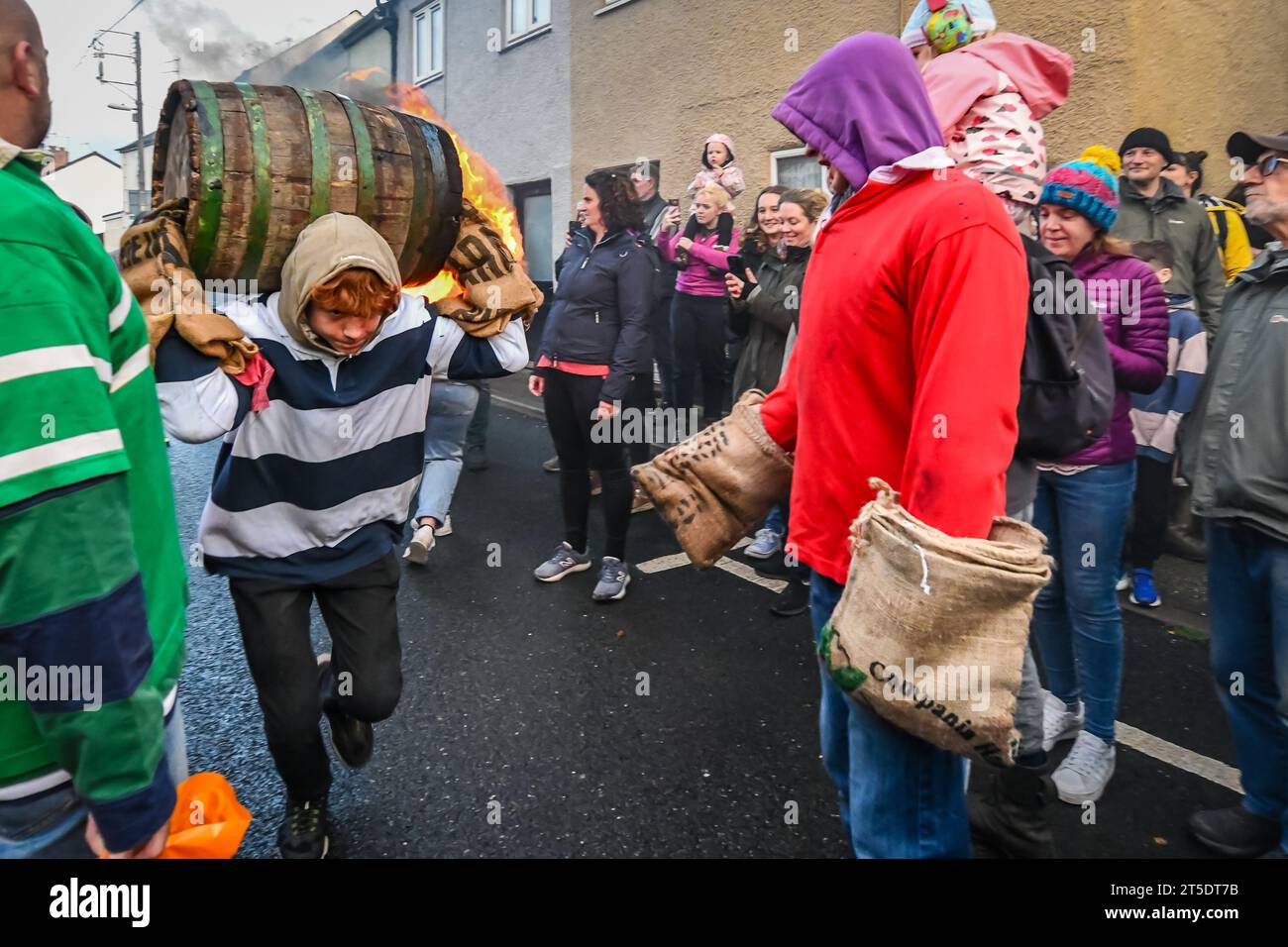 Ottery St Mary, UK. Saturday 4 November 2023. Brave children, as young as 7, take part in the Ottery St Mary Burning Tar Barrels. Running with burning barrels through the streets of Ottery St Mary, Devon in a traditional event stretching back hundreds of years. Credit: Thomas Faull/Alamy Live News Stock Photo