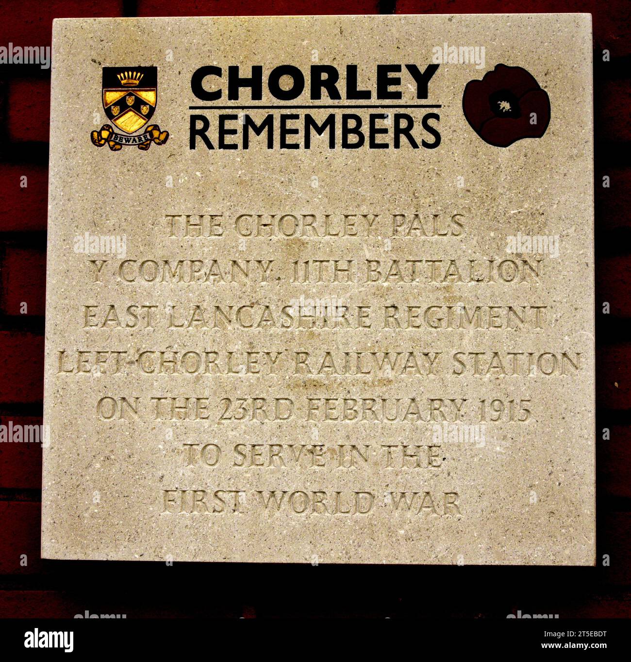 Text of a stone memorial to Chorley Pals Y Company 11th Battalion East Lancashire Regiment which left Chorley Railway Station, on the 23rd of February, 1915 to serve in the First World War. on the Southbound platform. The text does not have room to add that the Regiment went 'over the top on the Somme during the morning of the 1st July 1916 as ‘Y’ Company of the 11th (Service) Battalion (Accrington) East Lancashire Regiment.' and many dozens of men died. Stock Photo