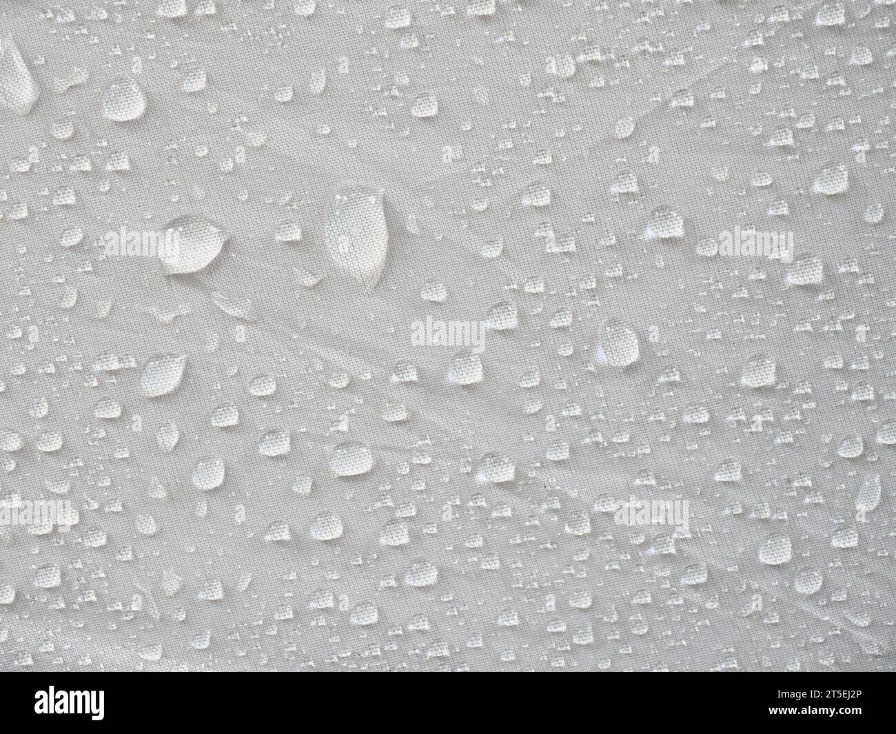 Water droplets on white textile, Moist rain drops on the surface of the