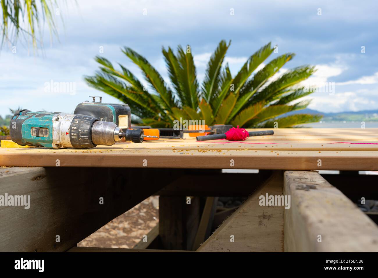 Eyelevel view old builders tools and red string on new wooden decking